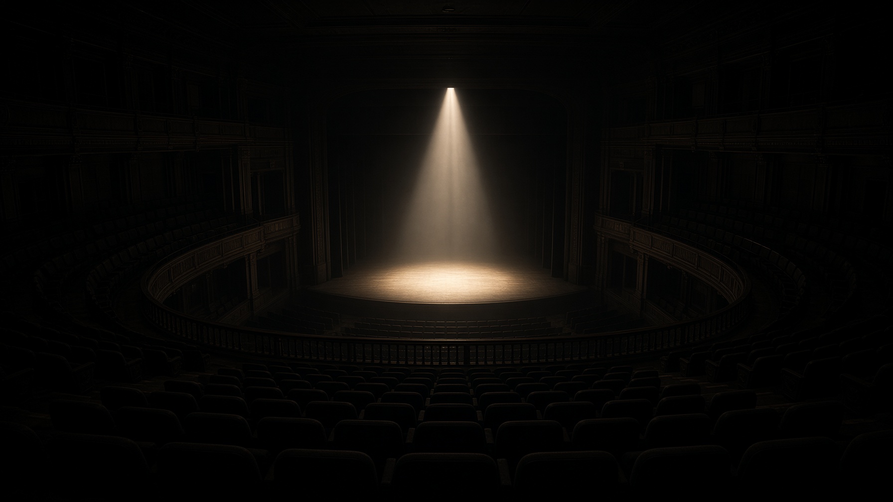 An empty concert hall under a single shaft of light